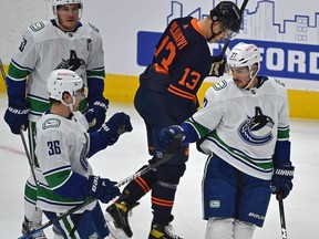Vancouver Canucks Travis Hamonic (27) celebrates his goal with Nils Hoglander (36) against the Edmonton Oilers during NHL action at Rogers Place in Edmonton, May 6, 2021.