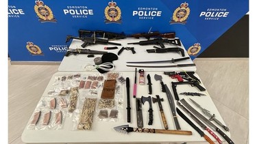 Items seized during the execution of a search warrant on May 21, 2021, in Edmonton's northwest are displayed in a photo supplied by the Edmonton Police Service.