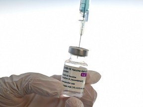 A health worker prepares a dose of the AstraZeneca vaccine at a COVID-19 vaccination centre at the Wizink Center in Madrid on May 12, 2021.