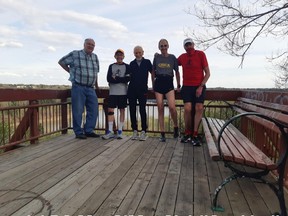 Friends seeking to place a bench overlooking the river valley to remember the late Frank McNamara are U of A Chasquis running club president Bob Lafontaine, left, U of A professor emeritus Raleigh Whitinger, Antarctic Marathoner age-group champion Roy Svenningsen, national and world-class ultrarunner Stefan Fekner, and good friend Lou Hetke.