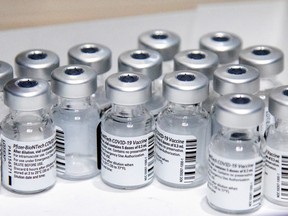 Empty vials of the Pfizer-BioNTech vaccine are seen at The Michener Institute, in Toronto. Alberta says Pfizer and Moderna are interchangeable as Canada's weekly shipment of Pfizer is delayed.