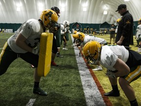 Players drill on the first day of the University of Alberta Golden Bears' football camp inside the dome at Foote Field in Edmonton, on April 26, 2018.