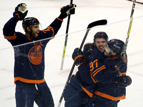 Darnell Nurse, Connor McDavid and Leon Draisaitl -- shown here celebrating McDavid's 100th point of the season --have all been major contributors to the Edmonton Oilers' fine showing in 2021.