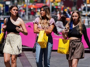 People walk without protective masks in Times Square amid the coronavirus pandemic in the Manhattan borough of New York, May 4, 2021.