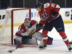 Edmonton Oil Kings goalie Sebastian Cossa (33) holds off Lethbridge Hurricanes Logan Barlage (27) during WHL action at the Community Arena in Edmonton, May 4, 2021.