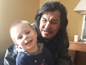 Clifford Mitchell, seen in February 2018 with his grandson Levi. Mitchell was one of three people who died suddenly in an Edmonton park on Friday, May 21, 2021, family say. A cause of death has not been determined.