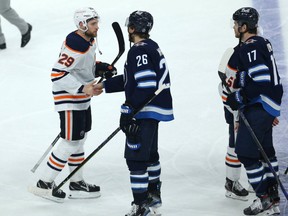 Winnipeg Jets captain Blake Wheeler (second from right) shakes hands with Edmonton Oilers forward Leon Draisaitl after the Jets swept the Oilers in a Stanley Cup playoff series in Winnipeg on Mon., May 24, 2021.