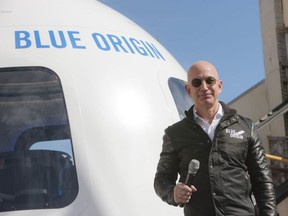Jeff Bezos, chief executive officer of Amazon.com Inc. and founder of Blue Origin LLC, smiles while speaking at the unveiling of the Blue Origin New Shepard system during the Space Symposium in Colorado Springs, Colorado, U.S., on Wednesday, April 5, 2017. Bezos has been reinvesting money he made at Amazon since he started his space exploration company more than a decade ago, and has plans to launch paying tourists into space within two years. Photographer: Matthew Staver/Bloomberg ORG XMIT: 700030939