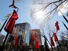 Dresses hang in Beaver Hills House Park (corner of Jasper Avenue and 105 Street) as part of Red Dress Day, in Edmonton Wednesday May 5, 2021. Red Dress Day is a national day of awareness for missing and murdered indigenous women and girls. Photo by David Bloom