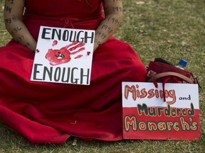 Betsy Wolfe takes part in Red Dress Day in Beaver Hills House Park (corner of Jasper Avenue and 105 Street), in Edmonton Wednesday May 5, 2021. Red Dress Day is a national day of awareness for missing and murdered indigenous women and girls. Photo by David Bloom