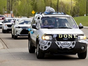 Graduates of Archbishop MacDonald High School take part in a graduation vehicle parade through the neighbourhoods of Laurier, Buena Vista, Parkview and Crestwood, in Edmonton Sunday May 24, 2020. Archbishop MacDonald High School's 2020 graduation commencement ceremony has been delayed until the fall, due to COVID-19.