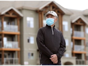Lao Huang poses for a photo outside his west Edmonton home, Friday, April 30, 2021. Huang, 72, said he was laid off from his part-time job at an Edmonton T&T Supermarket bakery shortly after the pandemic started.