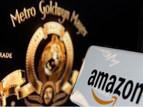 Smartphone with Amazon logo is seen in front of displayed MGM logo in this illustration taken, May 26, 2021.