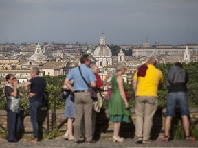Visitors look across the skyline in Rome on May 12, 2018. MUST CREDIT: Bloomberg photo by Giulio Napolitano ORG XMIT: 775164257