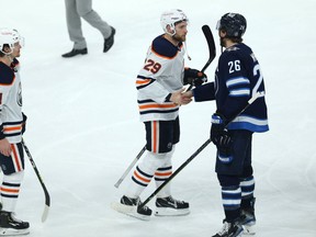 Winnipeg Jets captain Blake Wheeler (second from right) shakes hands with Edmonton Oilers forward Leon Draisaitl after the Jets swept the Oilers in a Stanley Cup playoff series in Winnipeg on Mon., May 24, 2021.