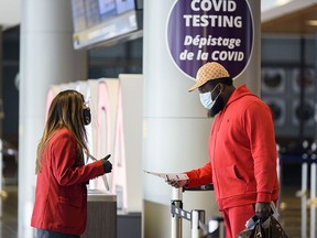 Upon arrival from overseas, travellers are informed about the Border Testing Pilot Program at YYC (Calgary International Airport) on Friday, Jan. 29, 2021.