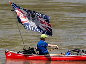 A canoeist flies the Treaty 6 flag while boating on the North Saskatchewan River in Edmonton, on Sunday, May 30, 2021. Treaty 6 is an agreement between the Crown and the Plains and Woods Cree, Assiniboine, and other band governments signed in 1876 at Fort Carlton and Fort Pitt. Photo by Ian Kucerak