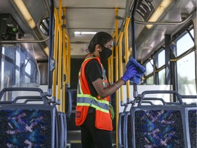 Harjas Grewal with Bee-Clean sanitizes the high touch surfaces is a Calgary Transit Bus. The City of Edmonton announced Thursday that it will no longer pursue contracting out bus cleaning duties, which will save more than 100 city jobs.