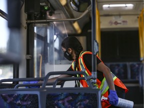 Harjas Grewal with Bee-Clean sanitizes the high touch surfaces in a Calgary Transit bus. The City of Edmonton is also looking at options to privatize bus cleaning which could lead to layoffs of more than 100 employees.