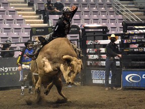Coy Robbins of Camrose holds onto his bull, Muddy Water, during the Professional Bull Riders Canada Finals at Revolution Place in Grande Prairie on Nov. 5, 2020.