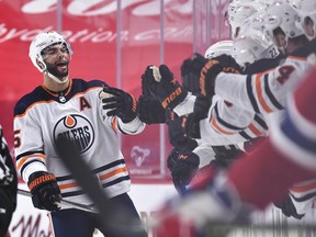 Darnell Nurse of the Edmonton Oilers celebrates his goal with teammates on the bench against the Montreal Canadiens at the Bell Centre on April 5, 2021, in Montreal.