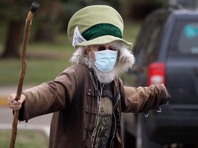 Lucien Faciote wears a mask to protect against COVID-19 as he walks along 111 Avenue near 105 Street, in Edmonton Tuesday June 8, 2021. Photo by David Bloom