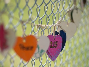 215 wooden hearts are visible outside Edmonton's Hazledean Elementary School, 6715 97 St., in honour of the child graves recently discovered at a Kamloops, B.C. residential school, Sunday June 13, 2021. Photo by David Bloom
