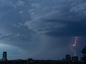 A thunderstorm passes east of downtown, seen from Strathearn Drive in Edmonton, on Monday, June 14, 2021. Photo by Ian Kucerak