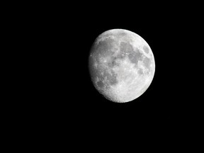 The moon rises over Edmonton, on Monday, June 21, 2021.