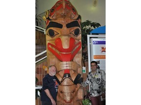 The Journal's Nick Lees, left, with Haida carver Ben Davidson with the totem pole Davidson carved for Stollery Children's Hospital in 2014. supplied