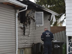 Fire investigators on the scene of a house fire along 35 St. near 18A Ave. which has sent a number of children and an adult to hospital in Edmonton, May 19, 2021. Ed Kaiser/Postmedia