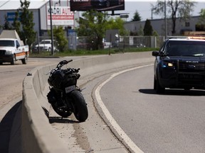 Police investigate the scene of a motorcycle crash on the Yellowhead Trail, west of Fort Road on Wednesday, June 2, 2021 in Edmonton.