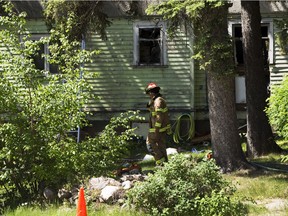 Firefighters inspect a home for hotspots after a home on Wadhurst Road near 103 Avenue was damaged by fire on Sunday, June 6, 2021 .  Greg Southam-Postmedia