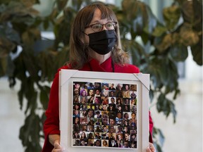 Lorna Thomas with Moms Stop the Harm holds a photograph of people that have died from substance related issues, waits to talk after Mental Health and Addictions critic Loris Sigurdson and MLA Janis Irwin at a press conference to put pressure on the UCP government to deal with the opioid crisis. Taken on Friday, June 11, 2021 in Edmonton.