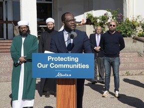 Minister of Justice Kaycee Madu provides details about a program to help protect religious and multicultural organizations targeted by hate-motivated crime, Friday, June 11, 2021, during a news conference in front of the Al Rashid Mosque in Edmonton.