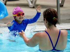 Cassidy Chugh (4) splashes into the arms of mom Charlotte McGinnis at Queen Elizabeth Outdoor Pool in Edmonton on Monday June 14, 2021, when the pool opened to the public. Pool goers have a time limit and must book ahead to be allowed admission into the facility.