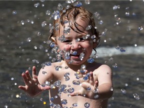 Blake Howell,3, stays cool in the fountain at City Hall as temperatures are expected to get to 26 C on Friday, June 25, 2021 in Edmonton.   Greg Southam-Postmedia