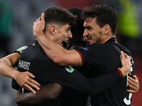 Germany's forward Kai Havertz, left, celebrates with Germany's defender Mats Hummels, right, after scoring their first goal during the UEFA EURO 2020 Group F football match between Germany and Hungary at the Allianz Arena in Munich on June 23, 2021.