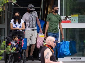 Calgarians exit the downtown Real Canadian Superstore on Sunday, June 20, 2021.