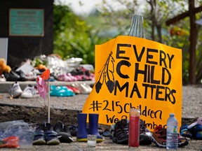 Hundreds of children's shoes remain in place at a memorial outside the Alberta Legislature building in Edmonton on Monday May 31, 2021. A vigil was held Sunday May 30, 2021 in memory of the 215 indigenous children whose remains were discovered on the grounds of a former Roman Catholic church residential school in Kamloops, B.C. (Photo by Larry Wong/Postmedia)