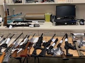 Grande Prairie RCMP found a loaded handgun, a machete, an axe, and two handgun magazines with ammunition after searching a vehicle near a school in that municipality on Tues., June 8, 2021. Police attended a call about a "disturbance" at a school and found the weapons inside the vehicle. Police seized 28 firearms and around 10,000 rounds of ammunition after later searching a home. (Photo supplied)