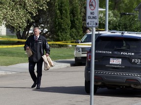 An ASIRT investigator is seen carrying bags of evidence to his vehicle on Sunday, June 6, 2021 after man was shot and killed in a confrontation with police near 134 Avenue and 107 Street in Edmonton’s Rosslyn neighbourhood on Saturday night.