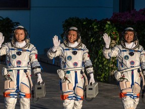 Chinese astronauts from China's Manned Space Agency, left to right, Tang Hongbo, Nie Haisheng, and Liu Boming wave at a departure ceremony before launch of the Senzhou-12 at the Jiuquan Satellite Launch Center on June 17, 2021 in Jiuquan, Gansu province, China.