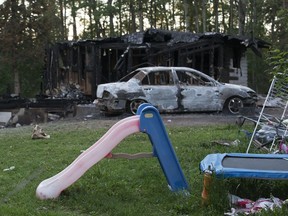 A children's slide and trampoline are visible at the scene of a fatal fire at 63007 Township Road 465, near Buck Lake, Alberta, Thursday June 3, 2021.
