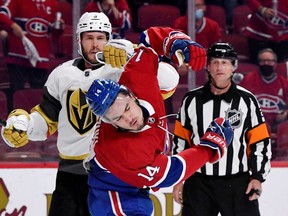 Vegas Golden Knights defenseman Brayden McNabb (3) punches Montreal Canadiens forward Nick Suzuki (14) under the eye of referee Chris Lee (28) in game four of the 2021 Stanley Cup Semifinals at the Bell Centre.