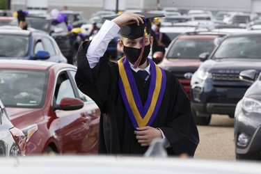 Mikayel Hakobian, 17, waits to pick up his diploma during Archbishop MacDonald High School's drive-in graduation ceremony, at the Edmonton EXPO Centre parking lot Friday June 4, 2021. The unorthodox ceremony was in response to COVID-19 health restrictions.