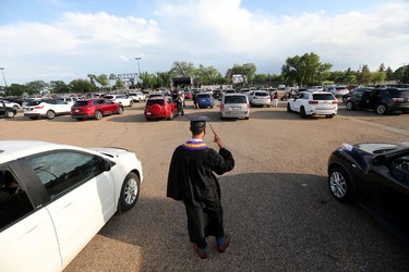 Ethan Robinson, 18, waits for his turn to receive his diploma during Archbishop MacDonald High School's drive-in graduation ceremony, at the Edmonton EXPO Centre parking lot Friday June 4, 2021. The unorthodox ceremony was in response to COVID-19 health restrictions.
