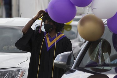 A student waits to pick up their diploma during Archbishop MacDonald High School's drive-in graduation ceremony, at the Edmonton EXPO Centre parking lot Friday June 4, 2021. The unorthodox ceremony was in response to COVID-19 health restrictions.