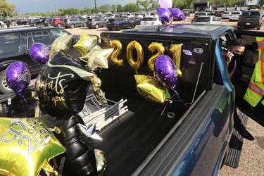 Raimond Delizo, 18, makes a phone call as he attends his drive-in graduation ceremony for Archbishop MacDonald High School, at the Edmonton EXPO Centre parking lot Friday June 4, 2021. The unorthodox ceremony was in response to COVID-19 health restrictions.