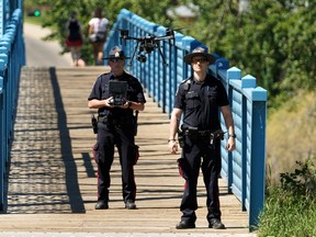 Edmonton police use a drone to search the North Saskatchewan River near the Dawson Bridge in Edmonton on Saturday June 26, 2021. A swimmer was reported missing in the river on Friday evening.